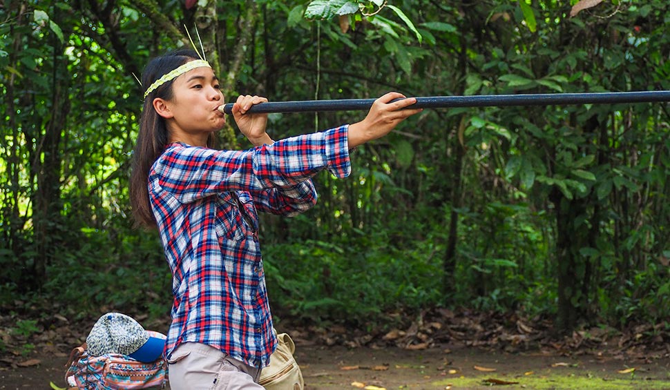 tourist woman using the blowgun